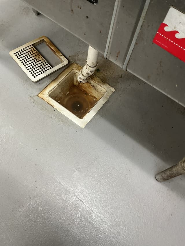 Standing Water in a Commercial Kitchen Floor Drain — Cleared in Austin — before